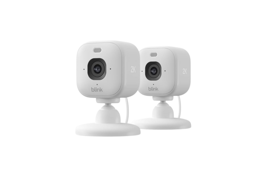 Blink Mini 2K+ plug-in indoor security cameras shown as a two-pack, featuring compact white design with 2K video resolution for home and pet monitoring.