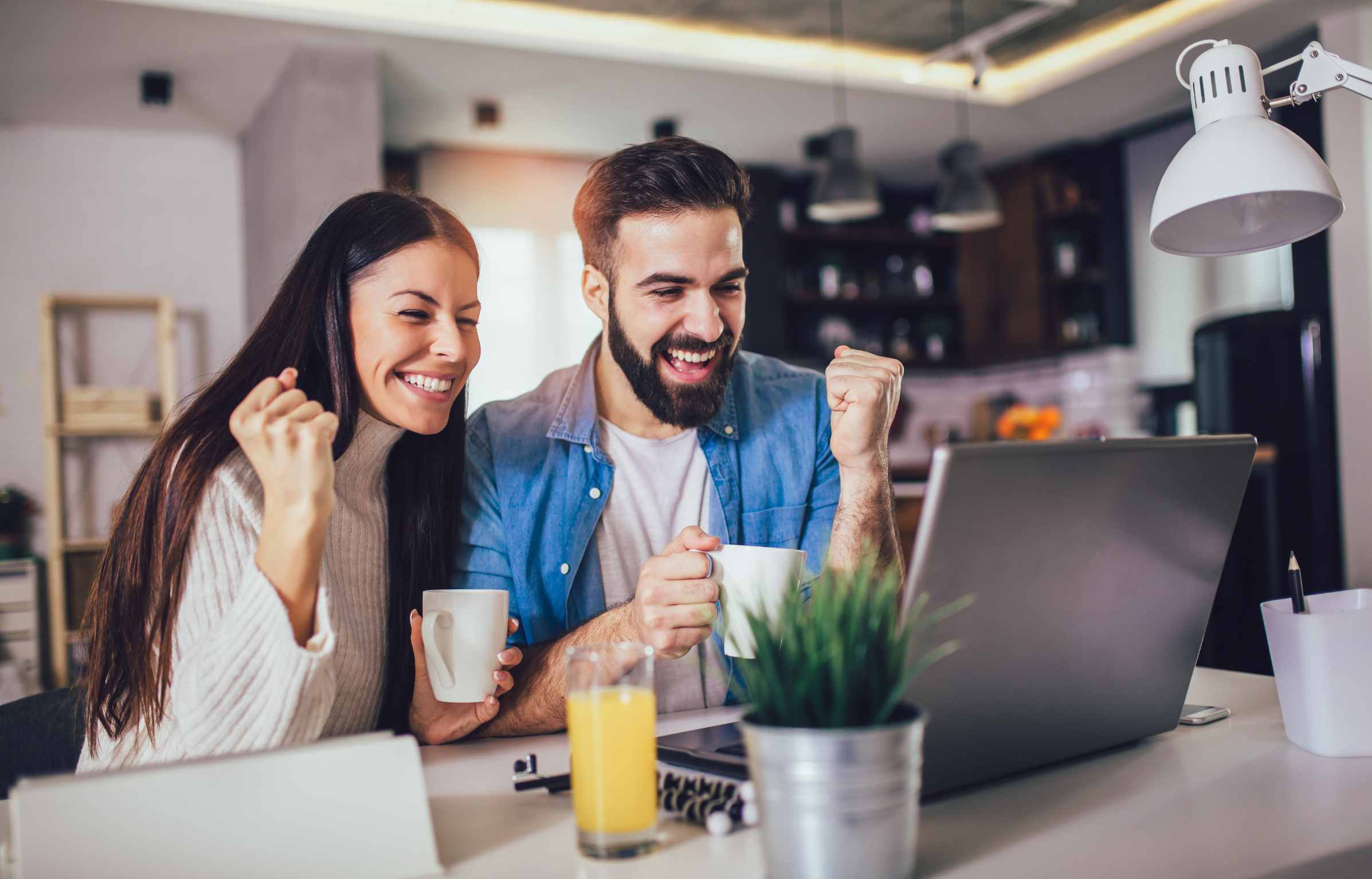 Excited Couple Finding Remote Jobs Online