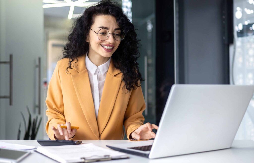 Smile Women Calculating Cost with Using Laptop