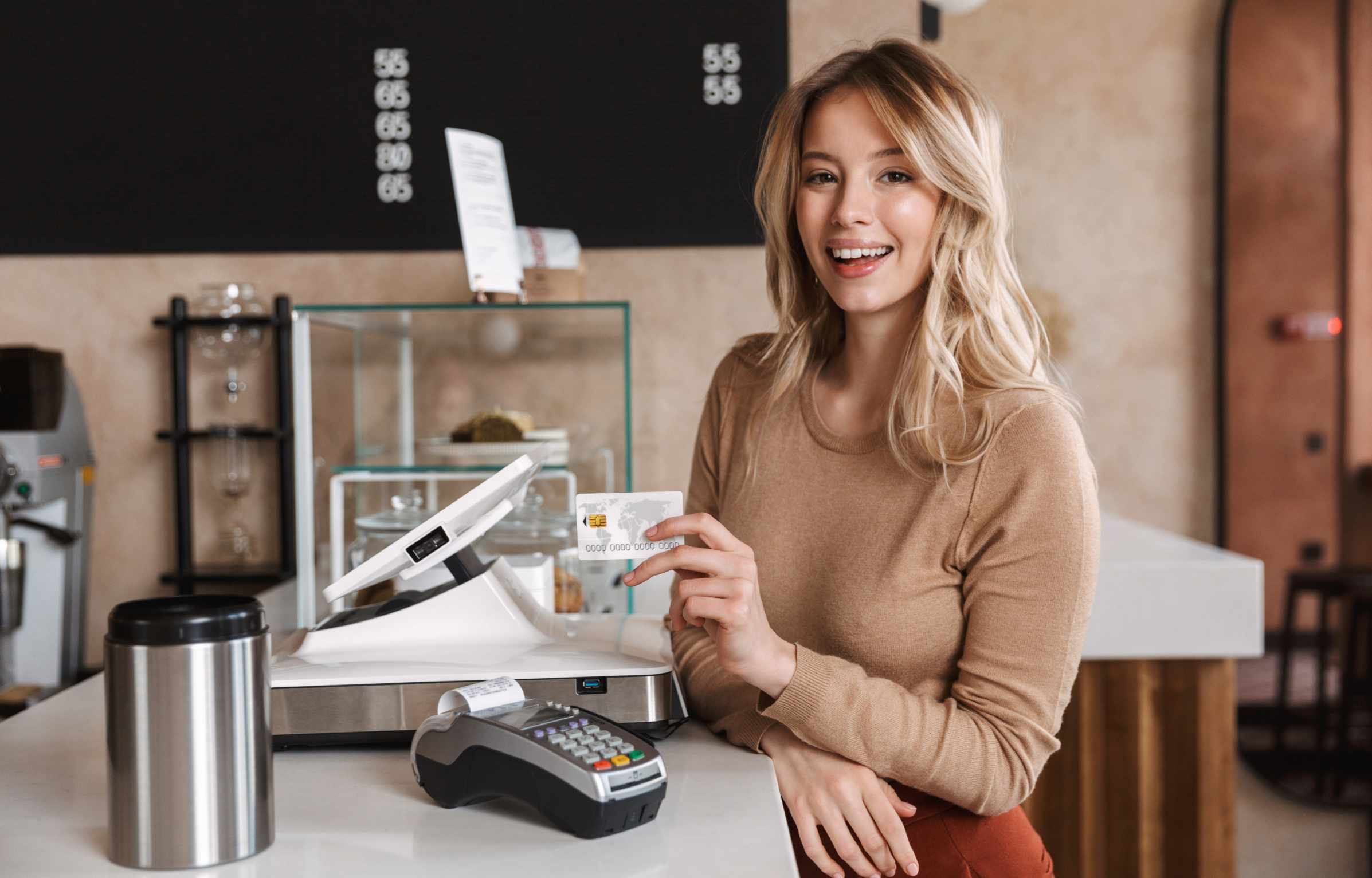 Happy Women at Cafe Counter Paying Bill with Credit Card