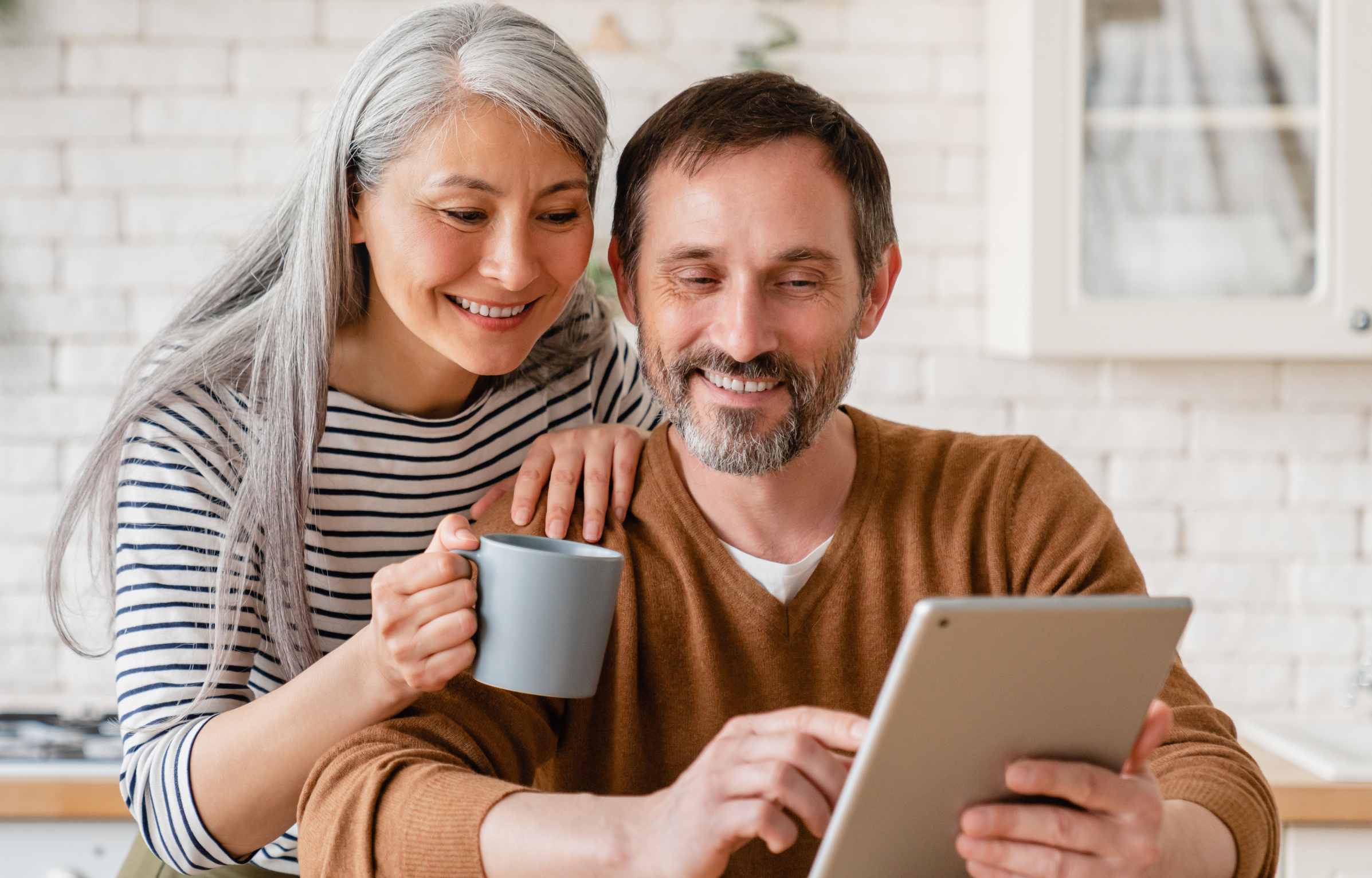 couple looking at retirement savings plan on tablet