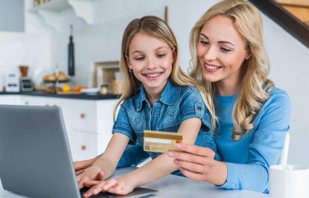 Cute women and a girl reading how to book a hotel with Chase points