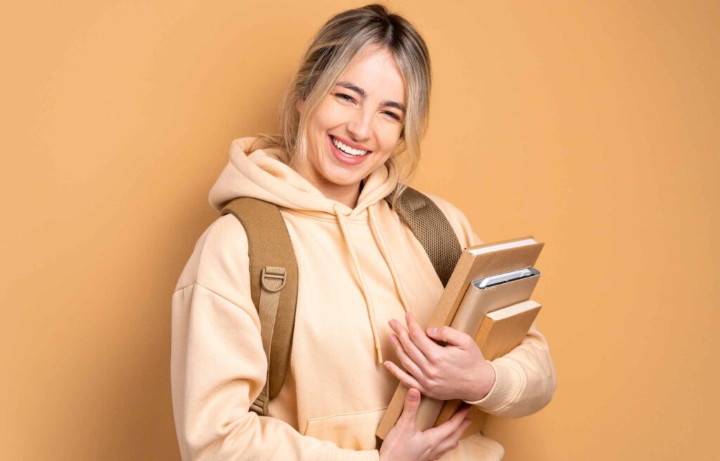 Happy Student Holding Books