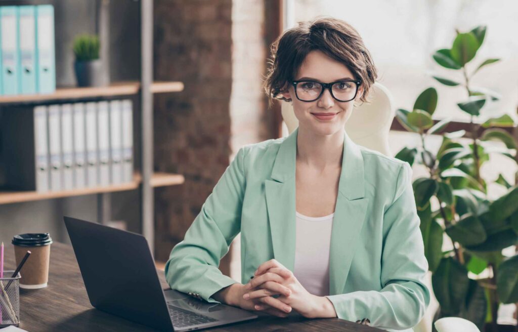 Portrait of independent start up development trainer coach girl sit table desk ready solve work decisions consult clients partners wear blazer jacket in workstation