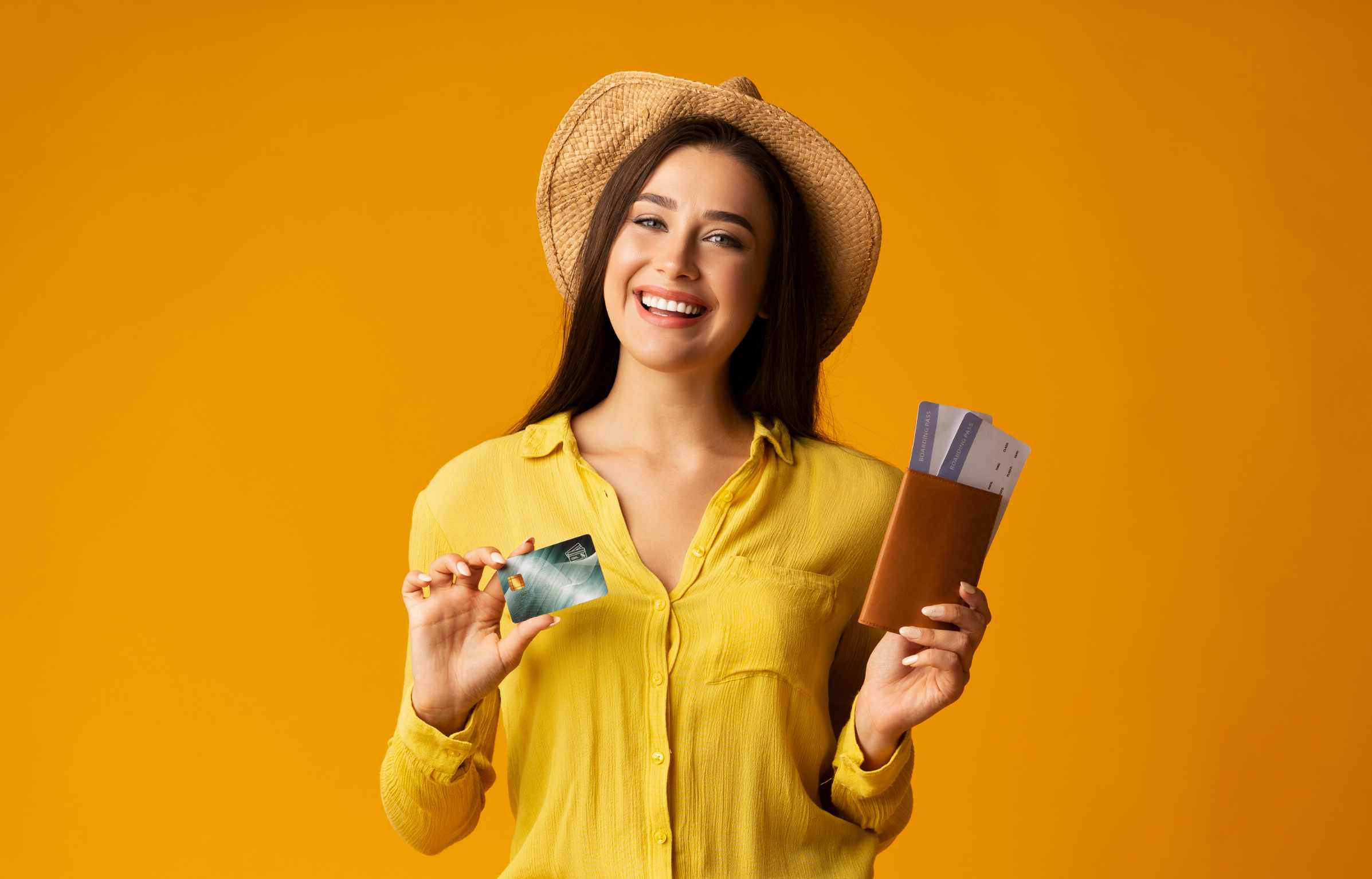 Charming Girl Holding Passport, Tickets And Credit Card On Yellow