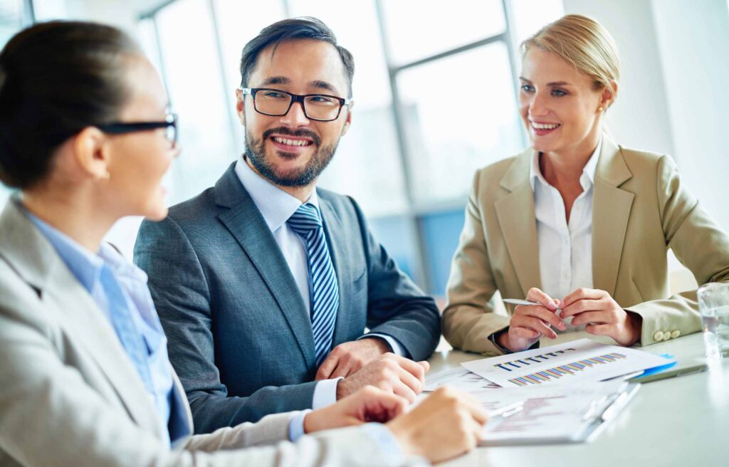 Group of young people discussing business while having meeting in the office