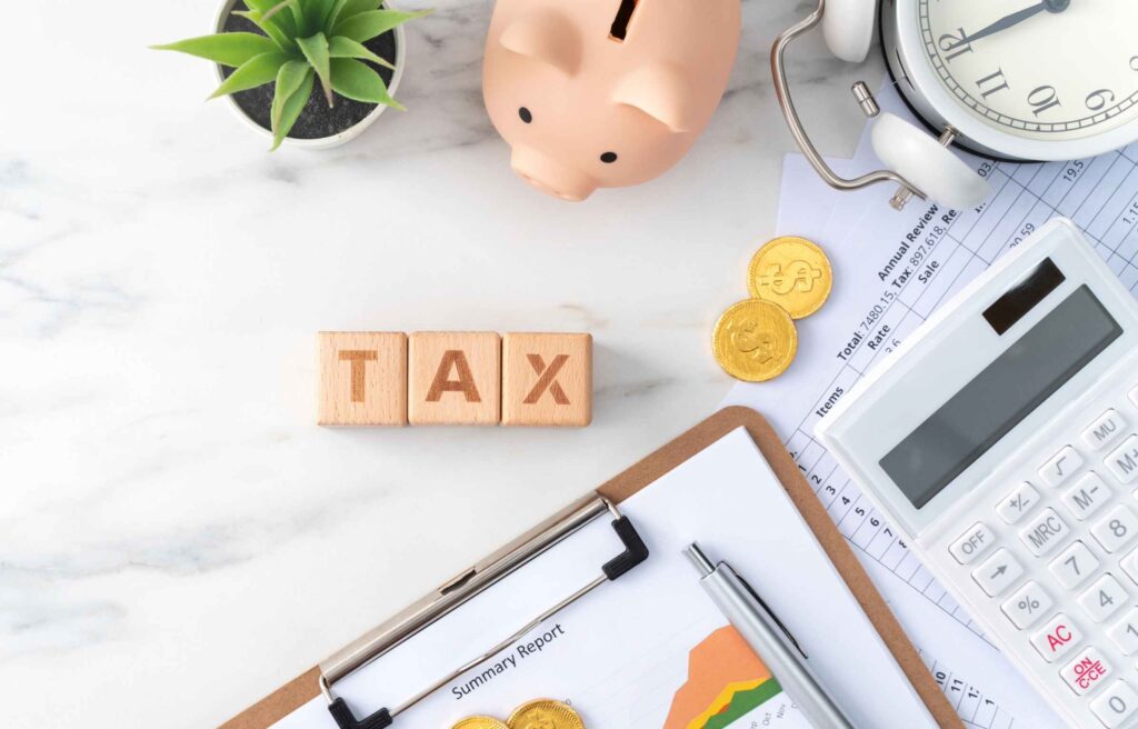 Top view of calculating and paying tax concept on marble white table.