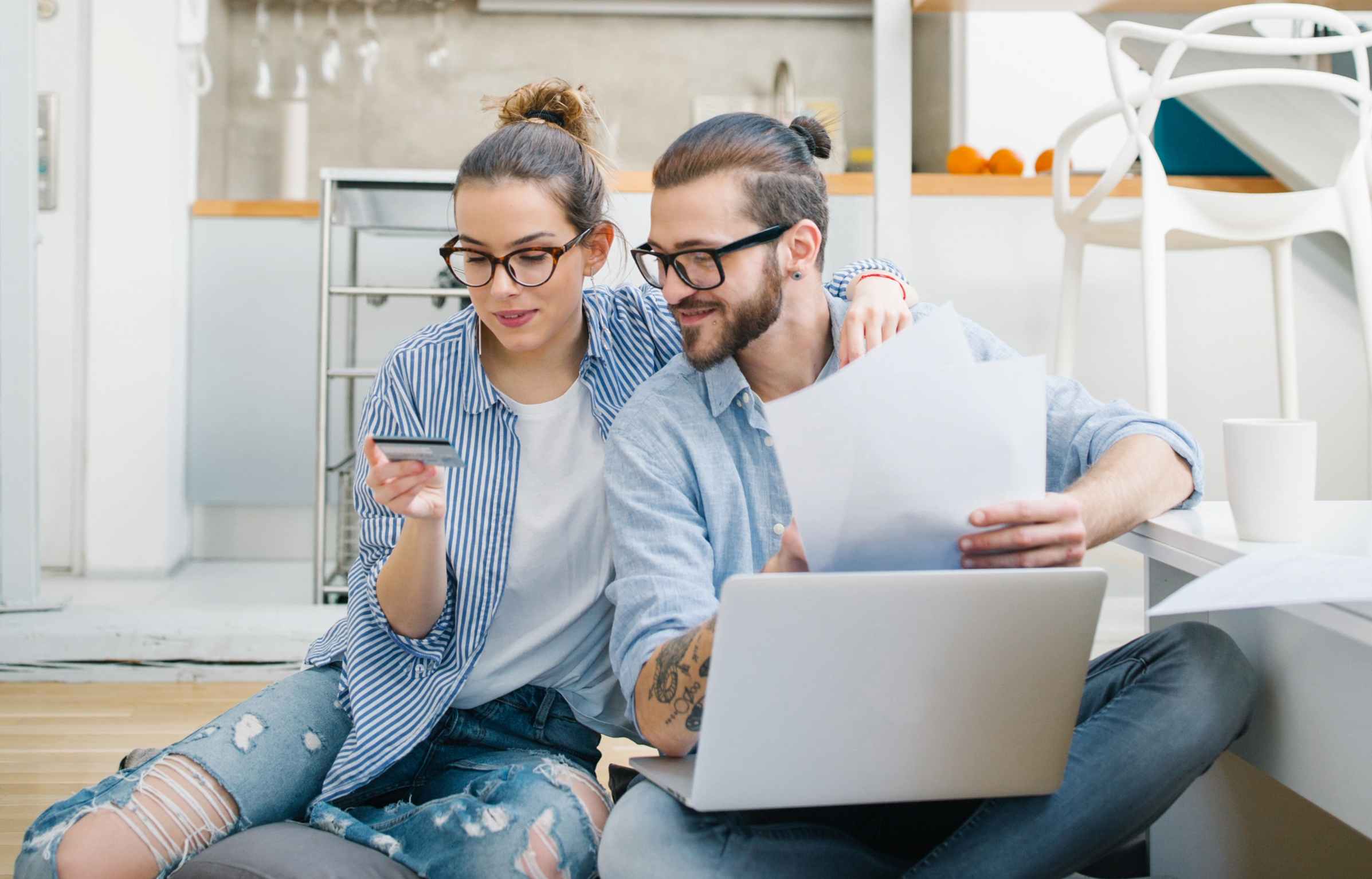 Young couple paying bills with credit card