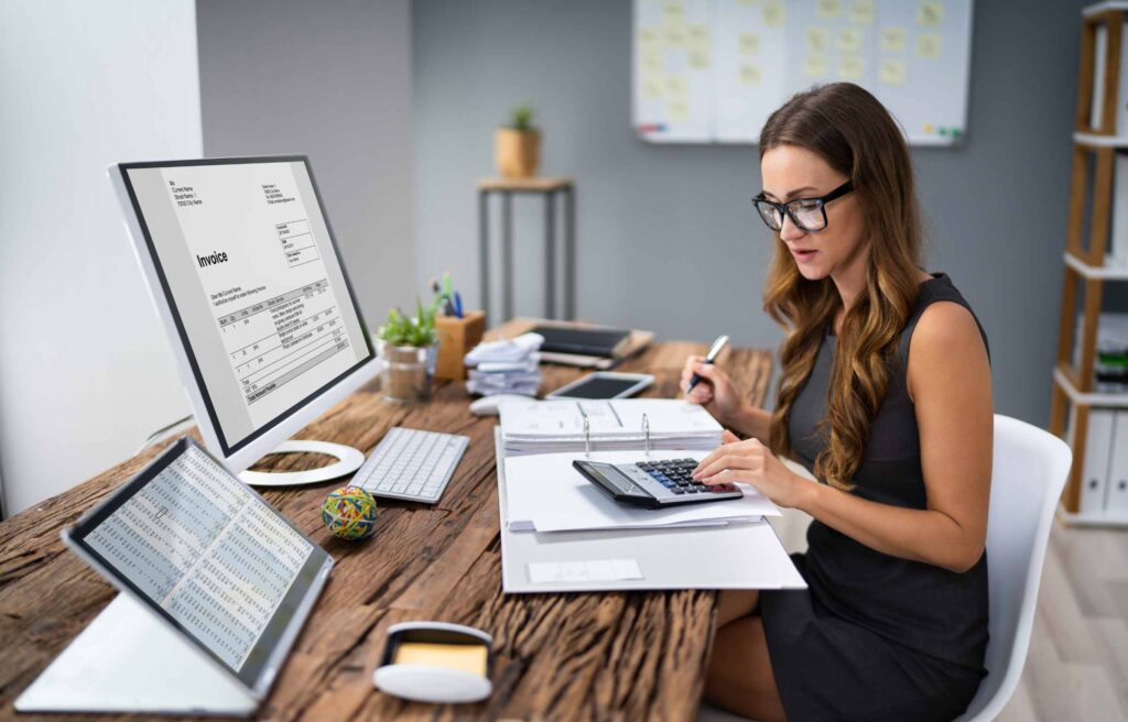 businessman working on desk office with using a calculator to calculate the numbers, finance accounting concept