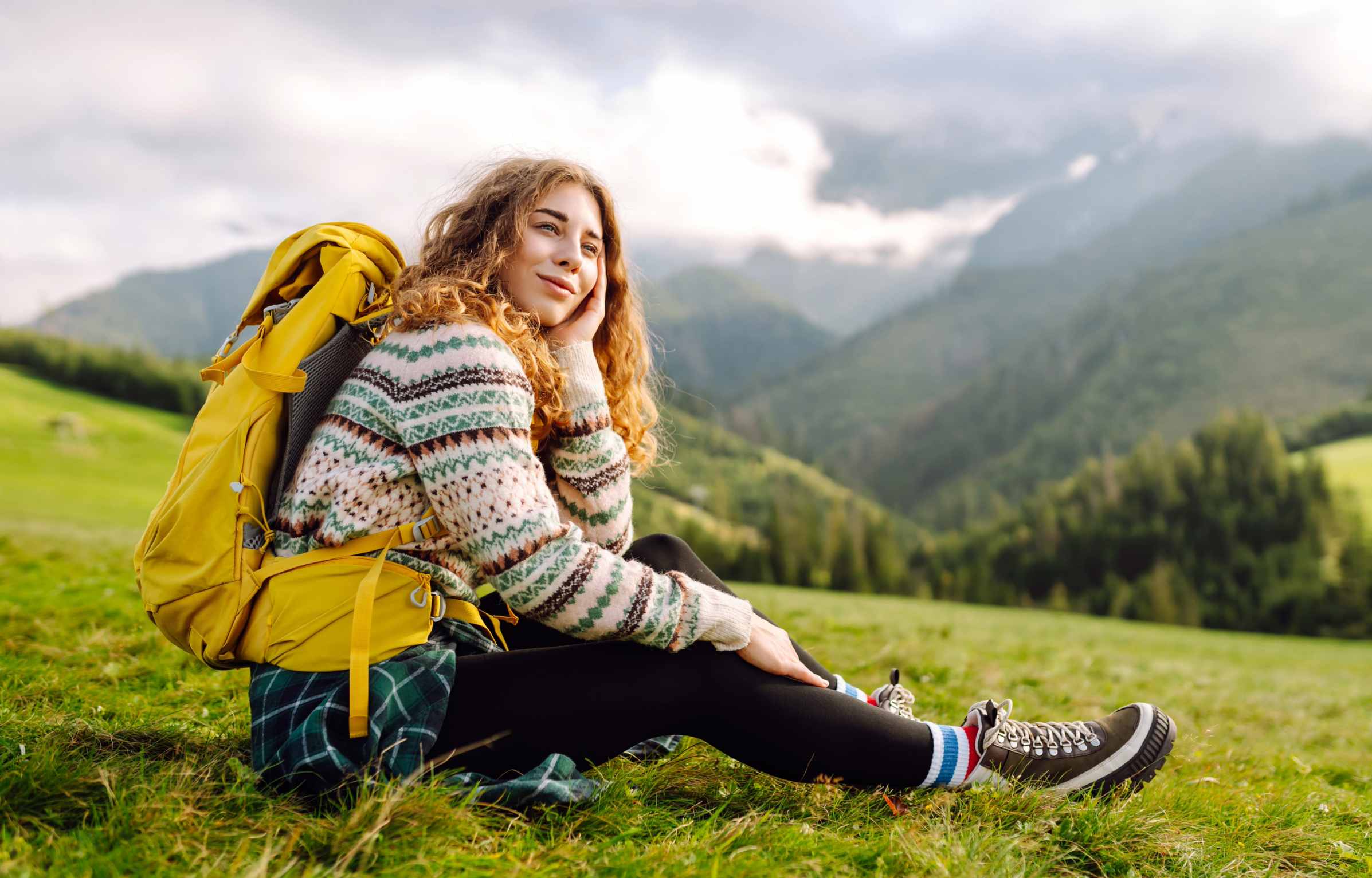 Happy Woman tourist admiring the landscape mountains nature. Exploring wilderness in National Park. Travel, hiking concept