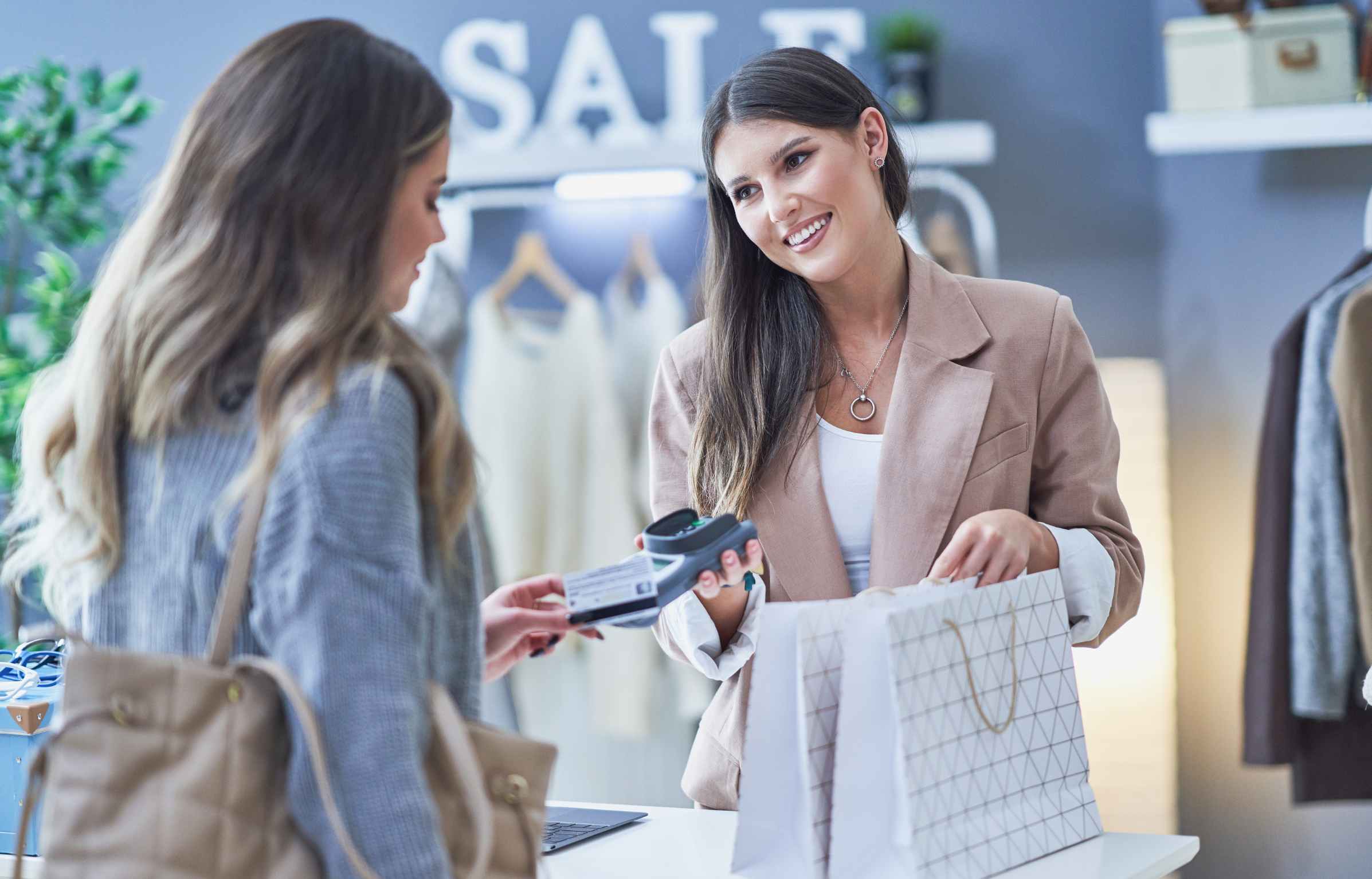 Woman Seller and Buyer in Clothes Store