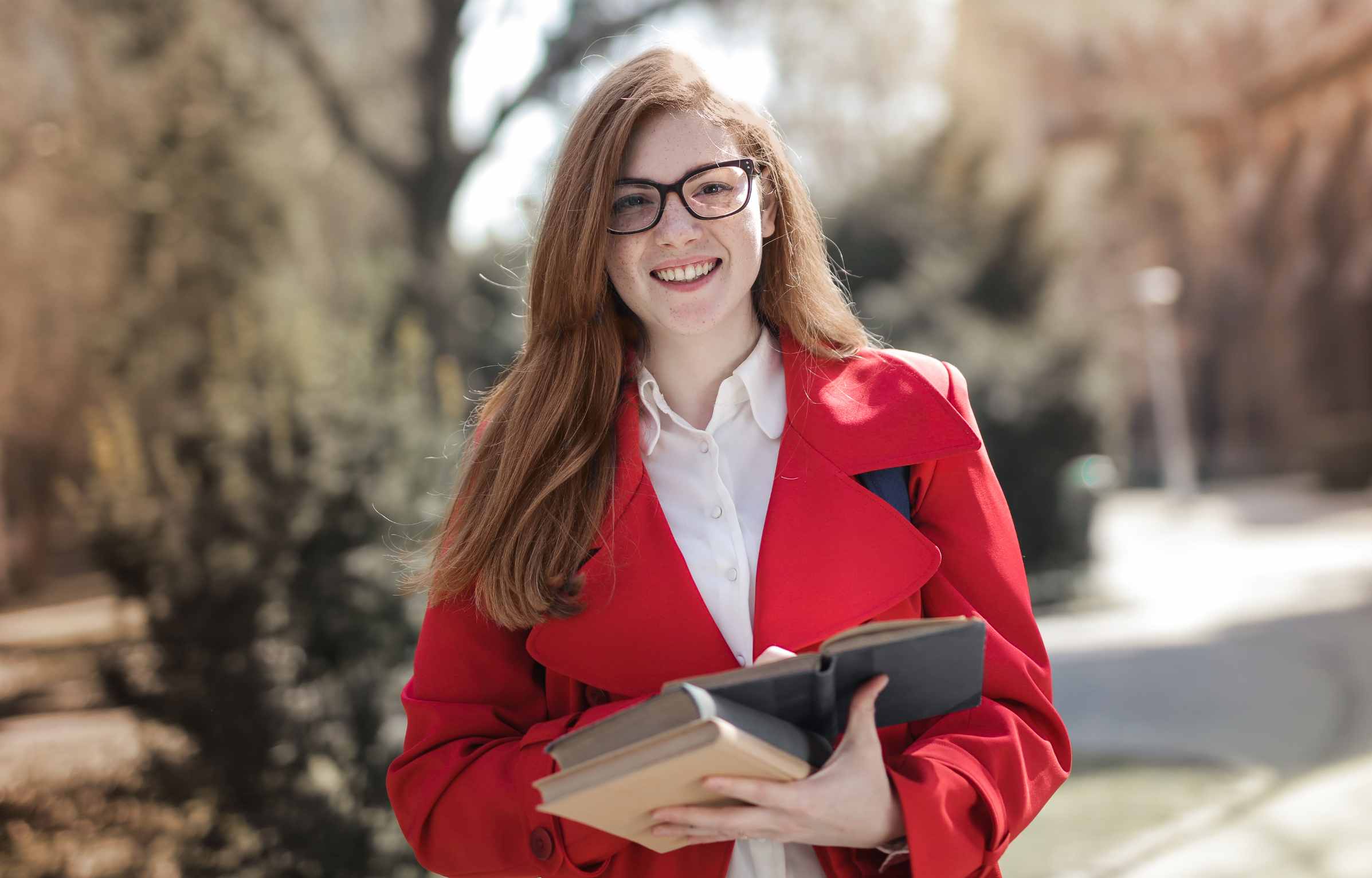 Woman in Red Blazer Wearing Eyeglasses Carrying Books