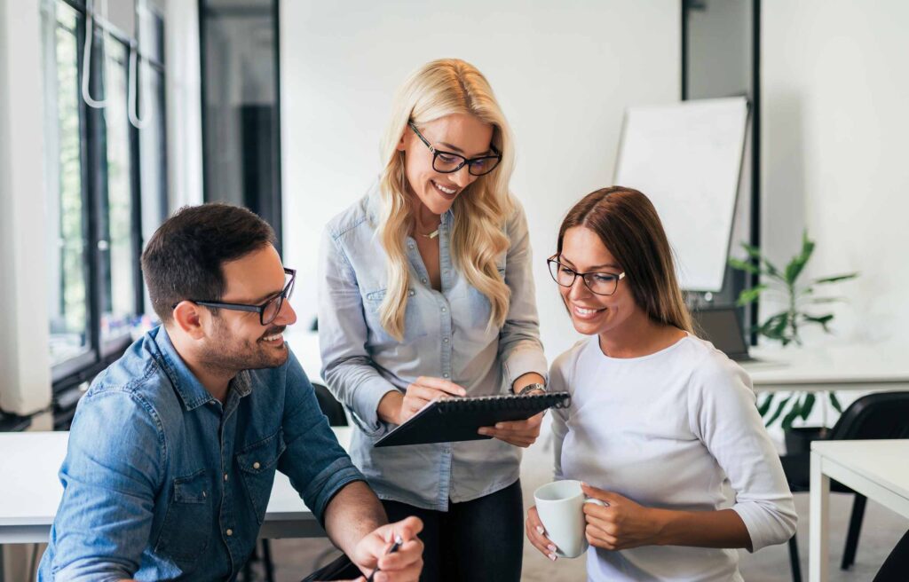 Three young casual business people working on a project
