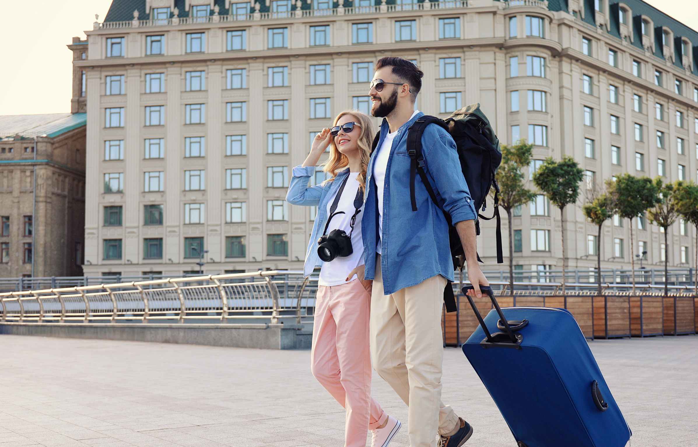Couple of Young Tourists with Luggage Outdoors