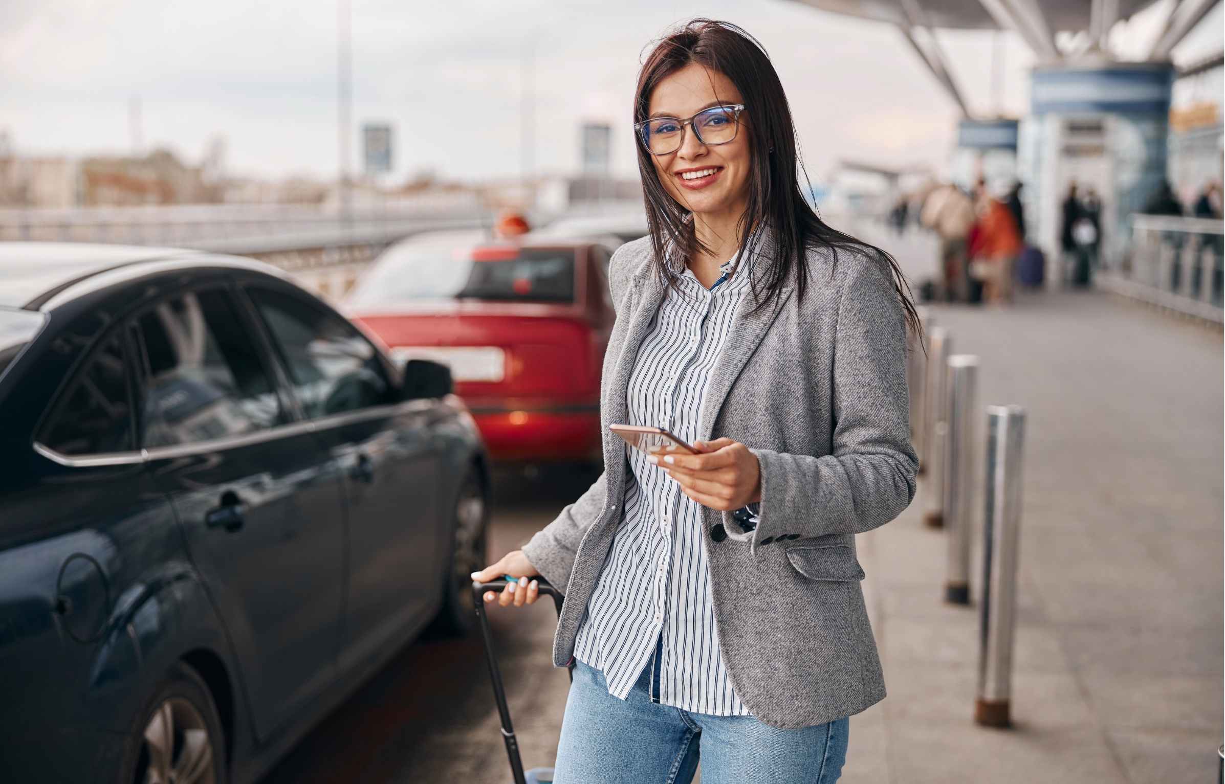Happy caucasian woman traveller in airport terminal is taking a taxi