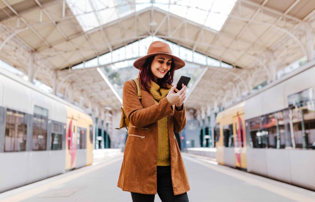 Tourist Woman Using Smartphone at the Train Station