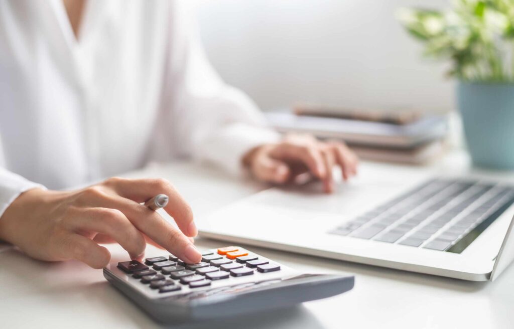 Woman entrepreneur using calculator, Saving money and calculatin