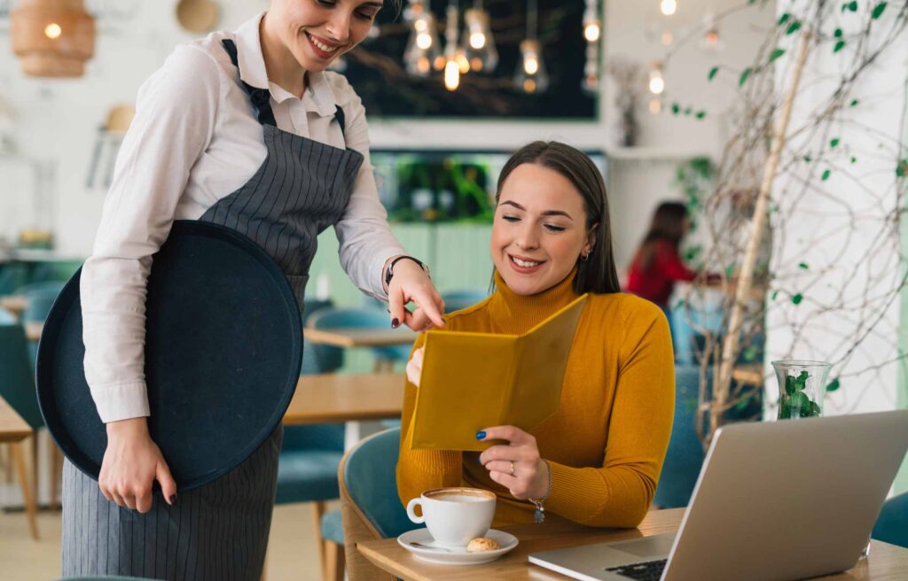 woman ordering food in digital priority pass airport lounge