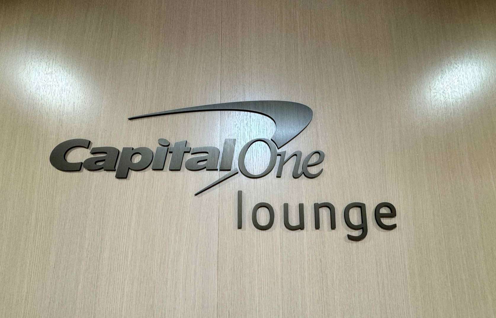 Capital One Lounge sign on wood wall
