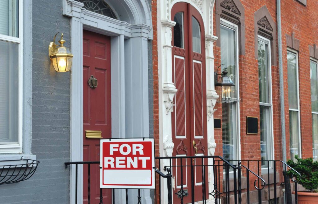 Urban townhouse with a 'For Rent' sign displayed, representing the need for rental dwelling insurance