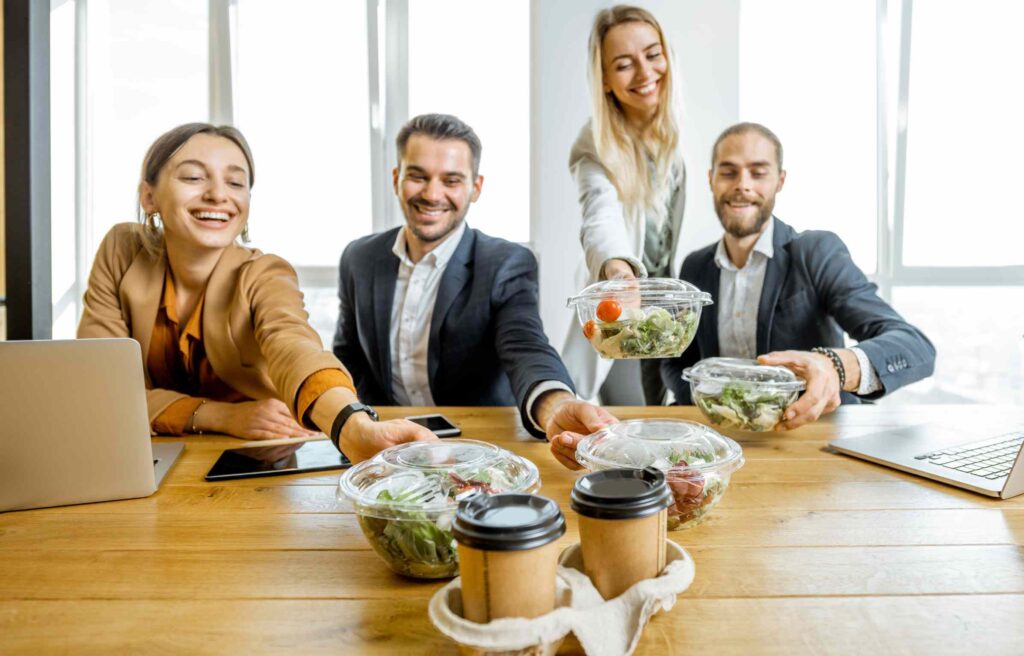 Team sharing delivered meals during a meeting, showing DashPass in action as a key perk of the chase ink business credit card.