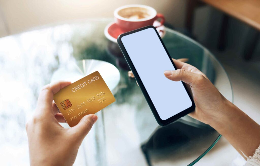 A women holding citi strata elite credit card