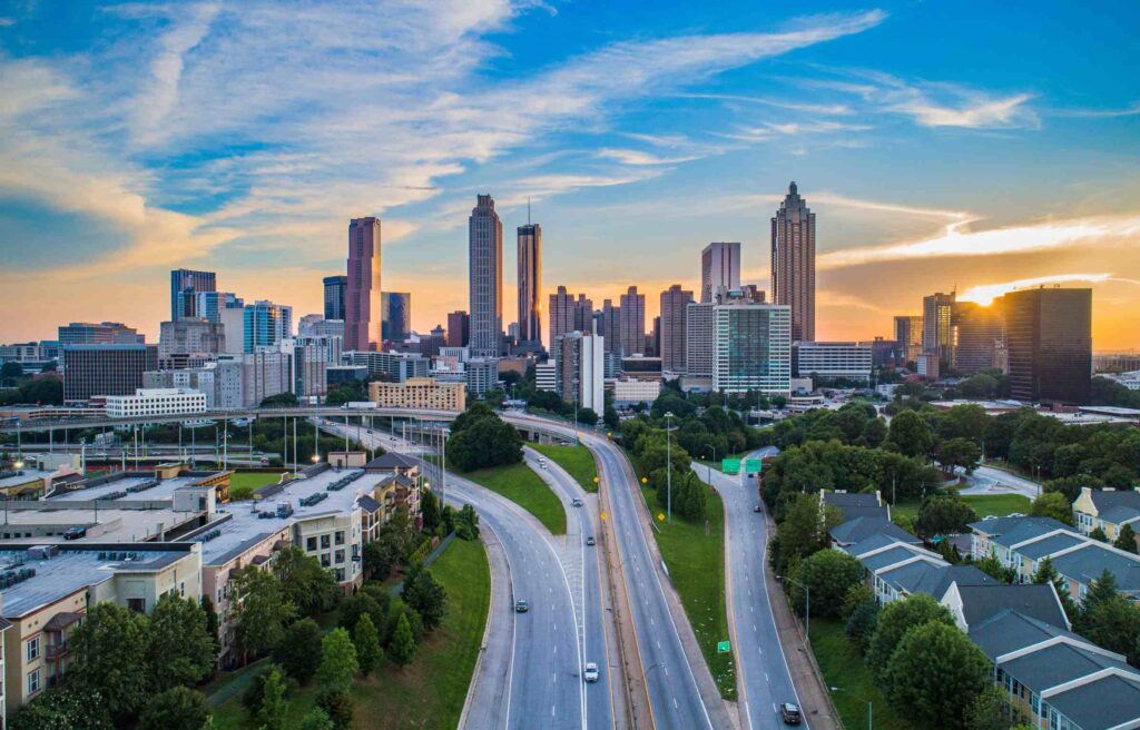 Atlanta Georgia skyline at sunset with highways leading into the downtown city center.
