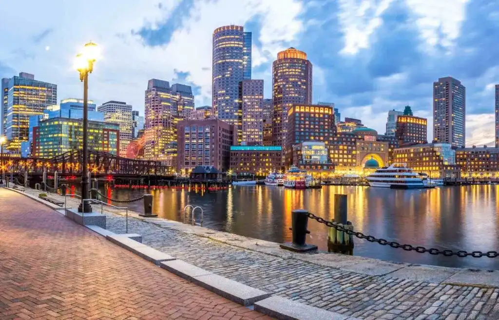 Boston city skyline at dusk with waterfront view, highlighting one of the best cities for registered nurses in the United States.
