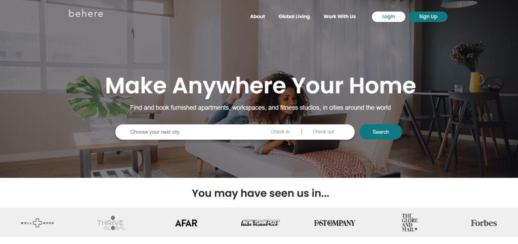 GoBeHere homepage showing a digital nomad woman using a laptop on a sofa in a modern living room.