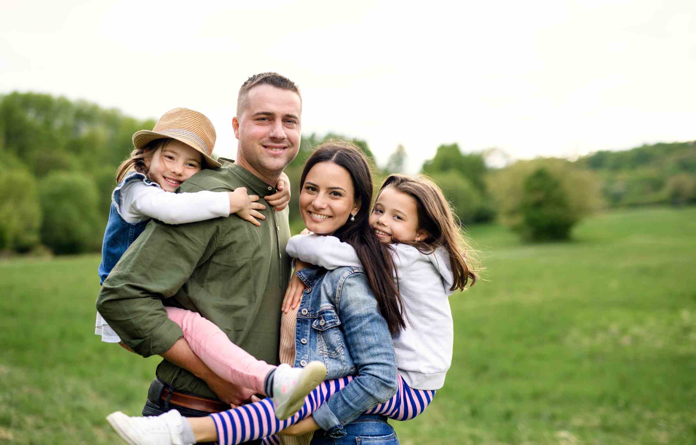 A gappy family with two children enjoying outdoor time together.