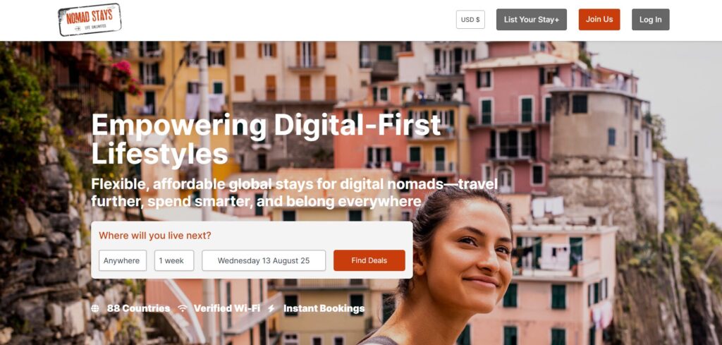 Nomad Stays homepage with a smiling woman in front of colorful cliffside buildings.