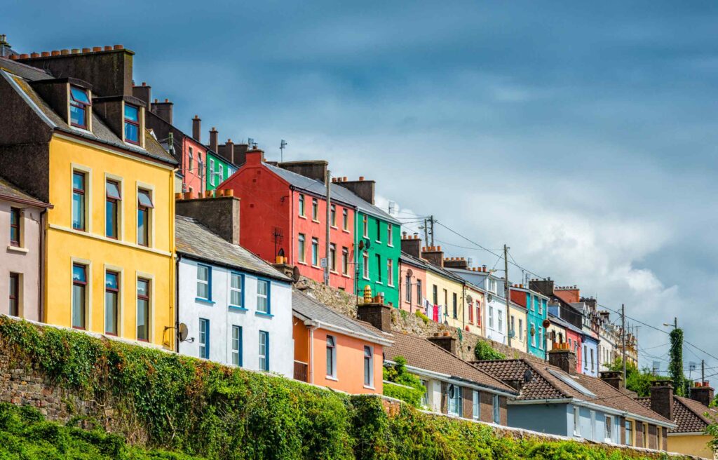Colorful houses in an Irish town symbolizing community and stability offered by ireland permanent residency.