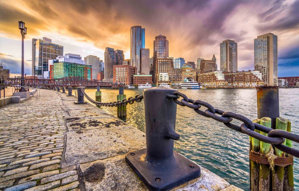 Boston, Massachusetts, skyline with waterfront view at sunset.