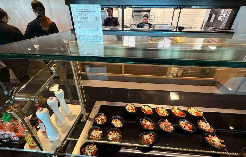 Small bowls of chickpea feta hash displayed at the Chase Sapphire Lounge counter.