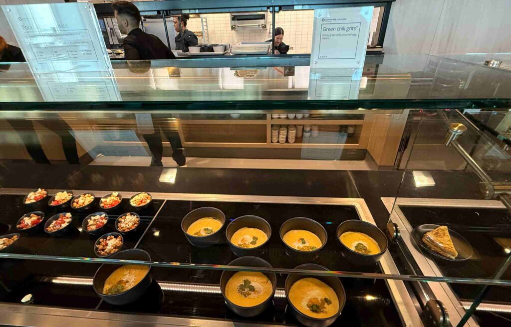 Bowls of green chili grits and salads were displayed at the Chase Sapphire Lounge counter.