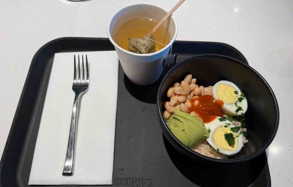 Breakfast bowl with eggs, avocado, beans, and tea from the chase sapphire lounge menu boston.