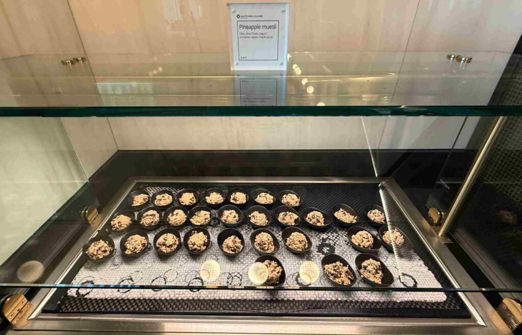 Small bowls of pineapple muesli are arranged neatly at the counter.
