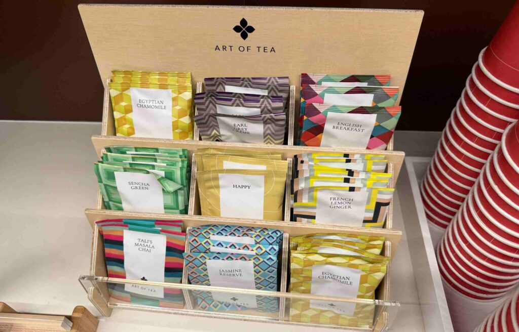 Display rack featuring assorted tea packets labeled Egyptian Chamomile, Earl Grey Crème, and English Breakfast.
