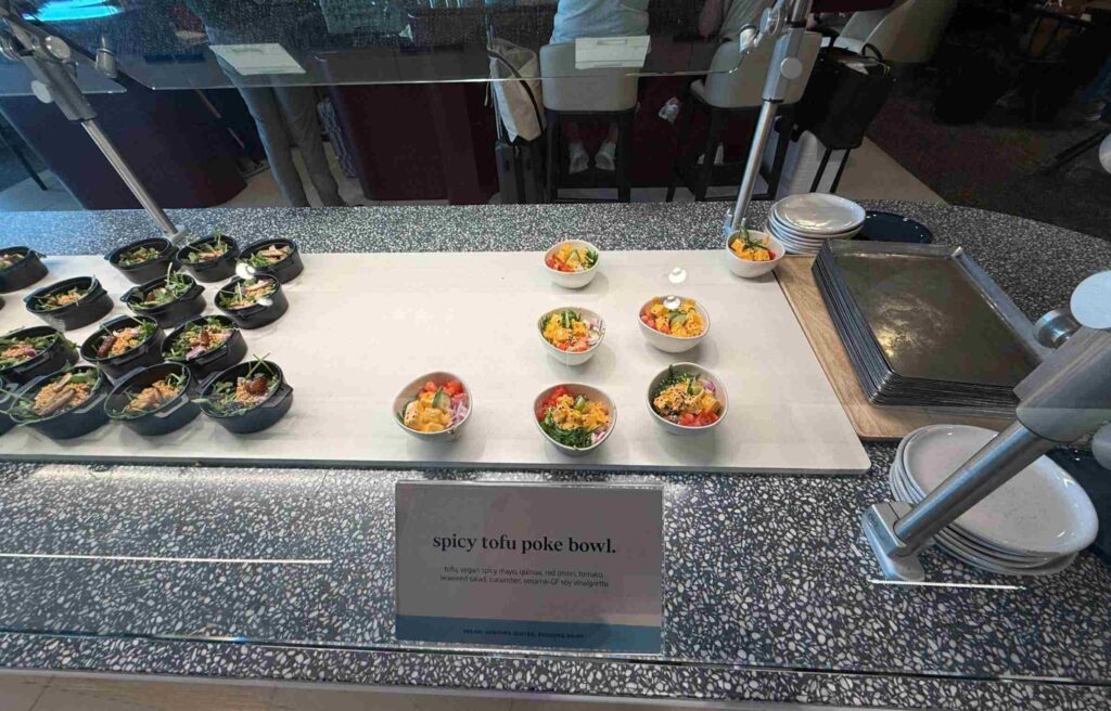 Colorful bowls of spicy tofu poke with quinoa, cucumber, and sesame vinaigrette.