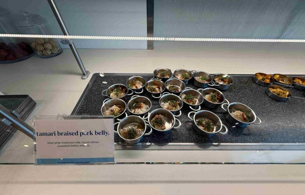 Mini pots of tamari braised pork belly served with rice and caramelized shallots.