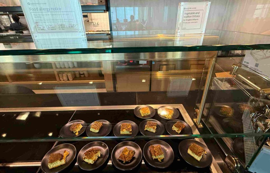 Plates of golden vegetable and scallion frittata displayed on the counter.