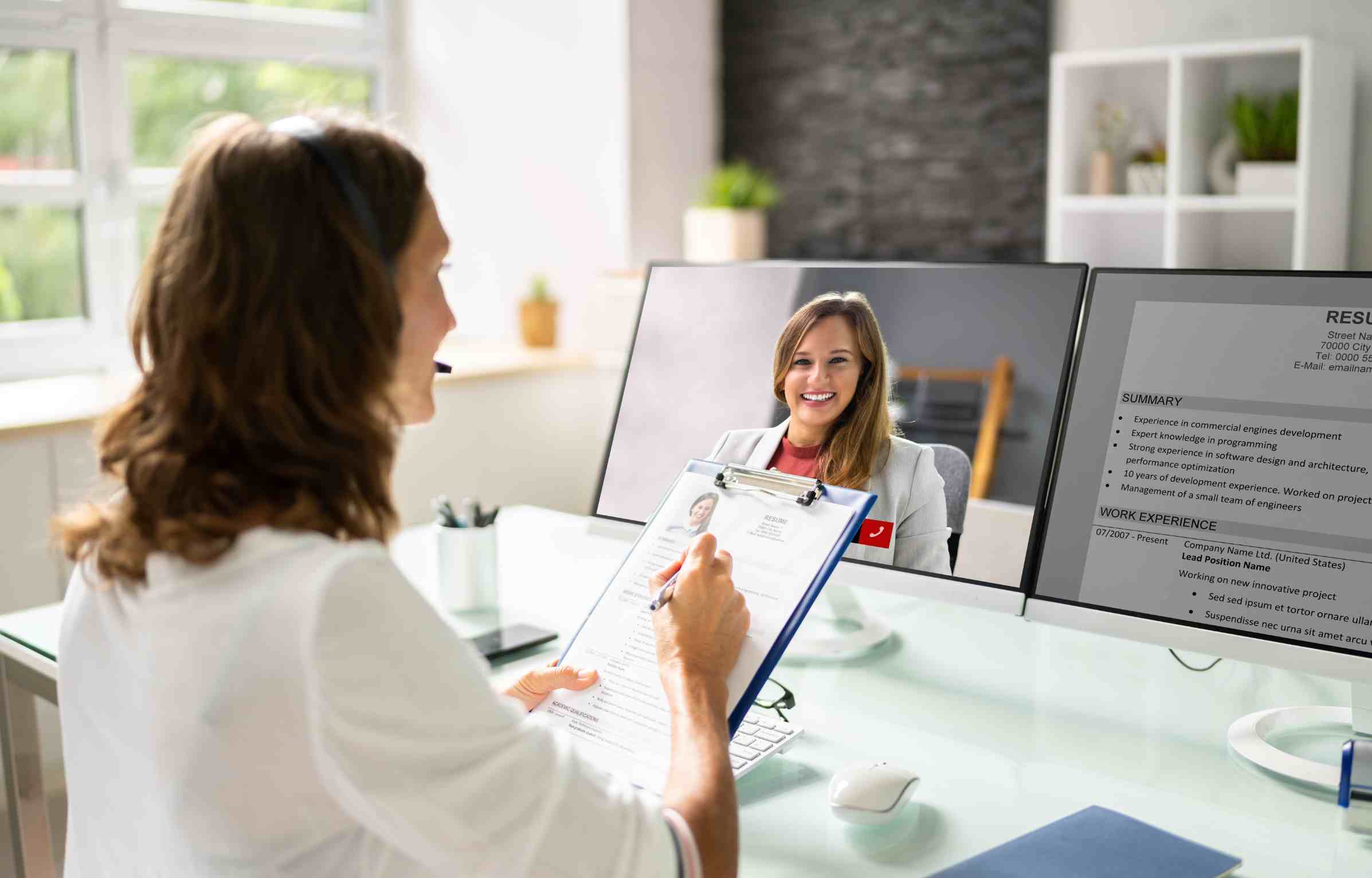 Recruiter conducting an online job interview with a candidate on a video call.