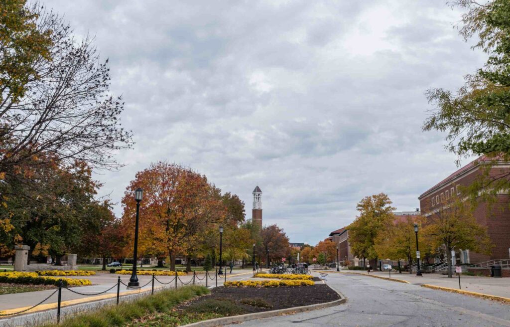 Autumn scene at Purdue University in West Lafayette, Indiana, with colorful trees, campus pathways, and the Purdue Bell Tower in the distance.