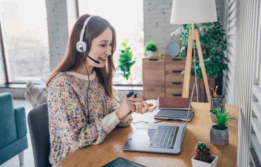A happy remote work woman during an interview for the tulsa remote work relocation program.