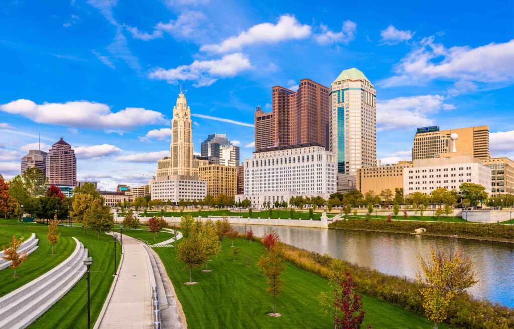 Skyline of Columbus, Ohio with modern and historic buildings by the Scioto River, highlighting one of the best cities for singles for affordable urban living.
