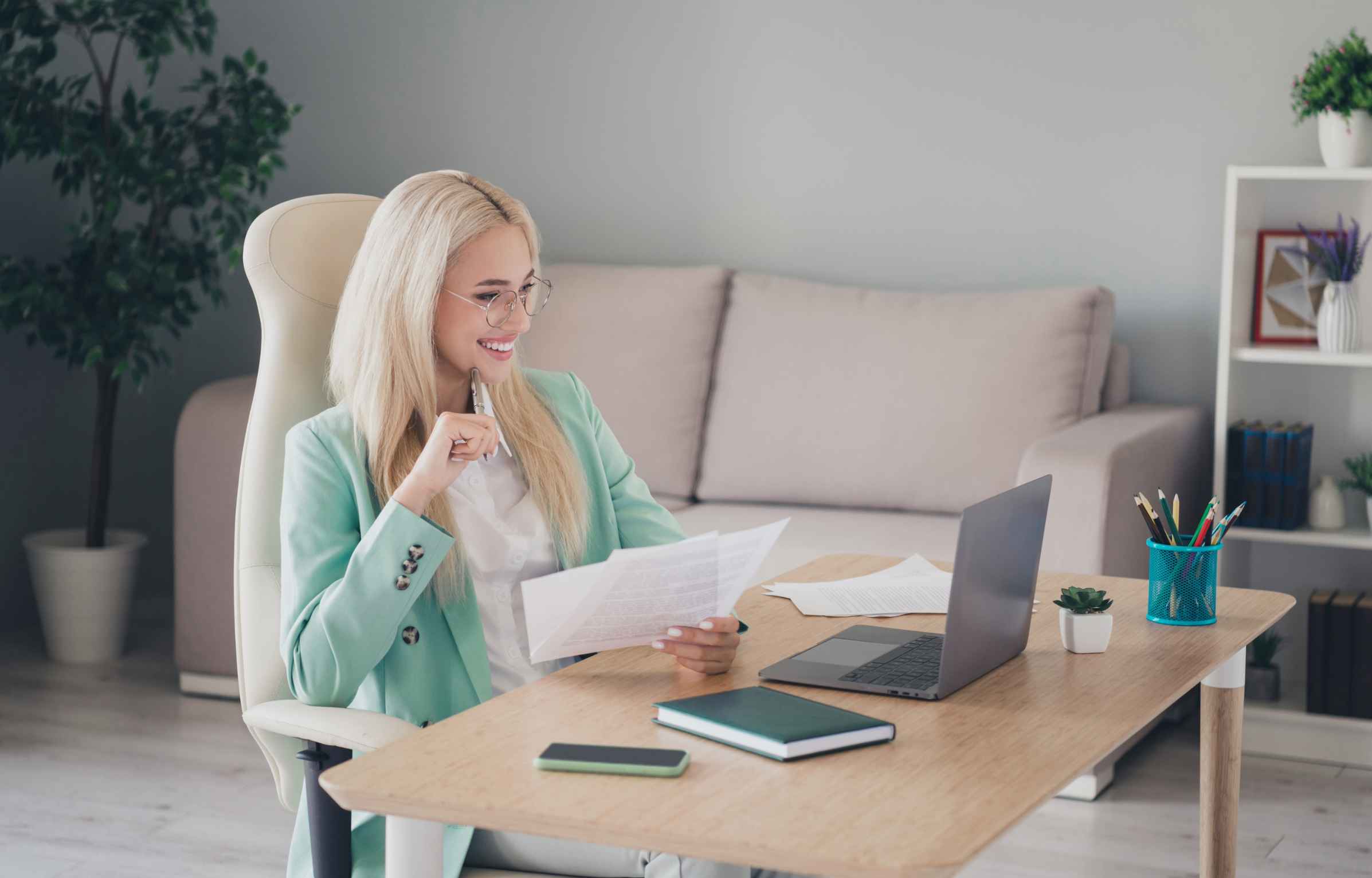 A happy remote work woman reviewing documents during an interview for the Tulsa Remote relocation program.