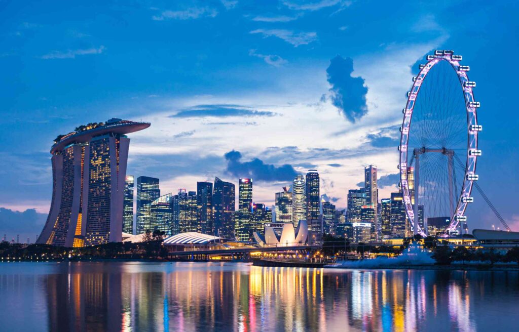 Singapore skyline at night with Marina Bay Sands and the Singapore Flyer, highlighting the appeal of singapore’s global investor program.