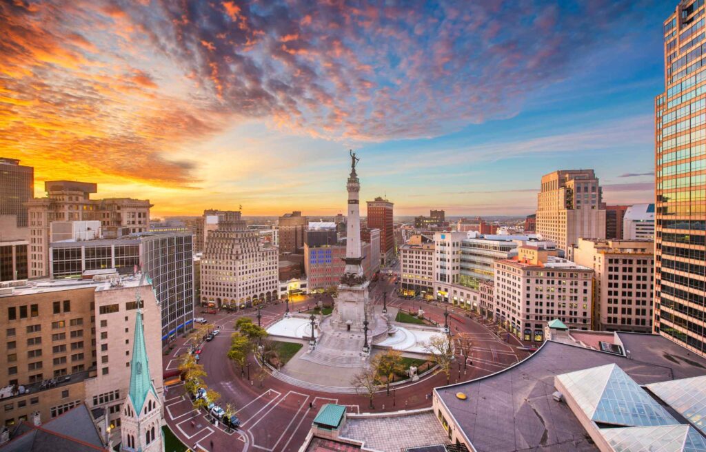 A panoramic view of Monument Circle and downtown Indianapolis at sunrise.