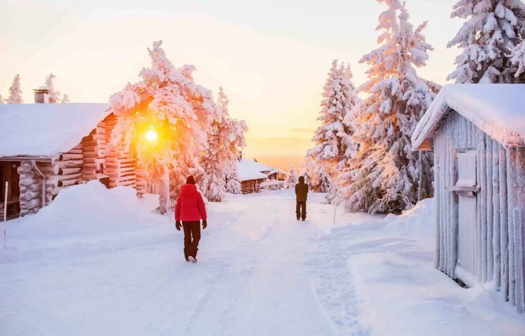snow-covered village in lapland, finland, one of the best places to spend christmas, with wooden cabins, frosted trees, and winter sunrise