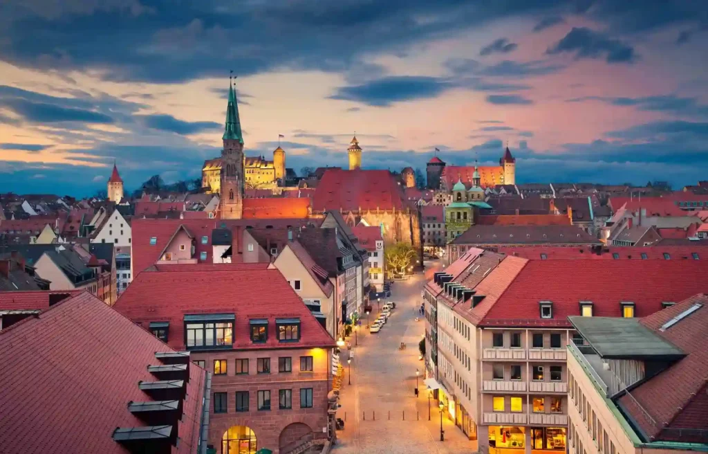 Nuremberg old town at dusk with historic rooftops, church towers, and softly lit streets during the winter season.